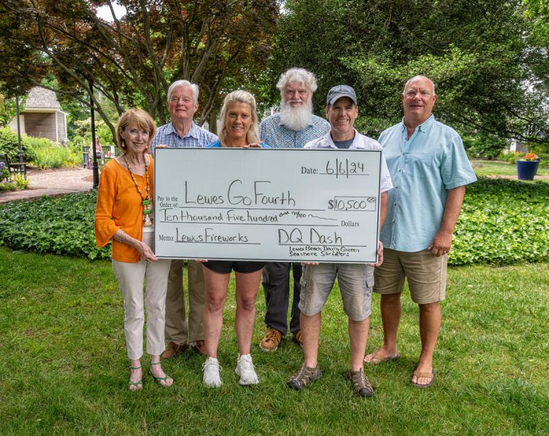 DQ Dash proceeds check presentation attendees shown are in back (l-r) Go Fourth Lewes Committee members Ted Becker and Paul Evalds, co-chairs; and Russ Palmer, chair. In front are Betsy Reamer, secretary; Ashley Diehl, Dairy Queen owner; and Tim Bamforth, Seashore Striders director. SUBMITTED PHOTOS